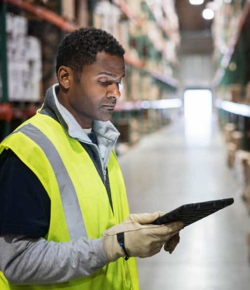 Single worker in distribution warehouse checking inventory