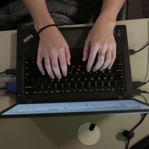 Overhead shot of hands typing on a Think Pad